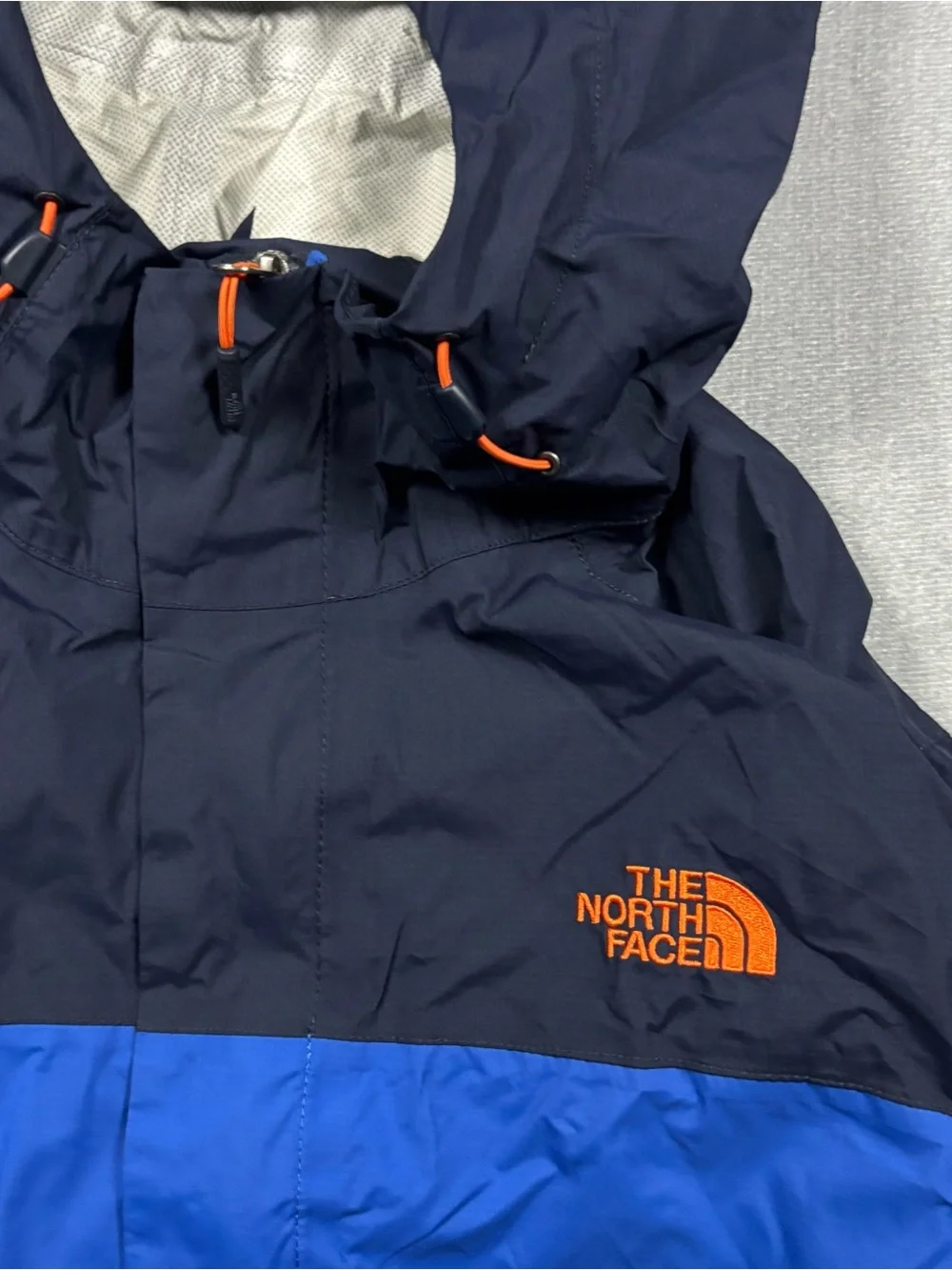 The North Face Navy & Royal Blue Hooded Rain Shell with Orange Accents